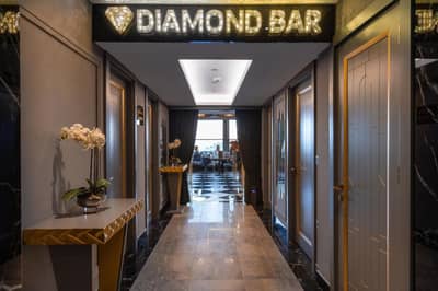 Grand Washington Hotel - a hallway with a diamond bar sign on the wall at Grand Washington Hotel in Istanbul
