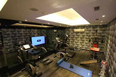 Grand Washington Hotel - a gym with tread machines and a tv in a room at Grand Washington Hotel in Istanbul