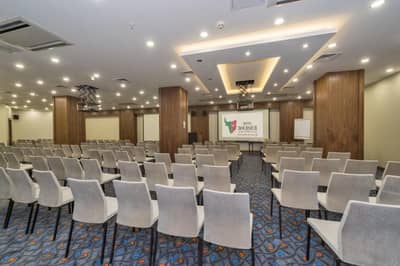 Hotel Boursier 1 & Spa - a conference room with rows of chairs and a screen at Hotel Boursier 1 &amp; Spa in Istanbul