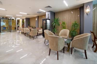 Hotel Bulvar Palas - a waiting room with chairs and tables in a lobby at Hotel Bulvar Palas in Istanbul