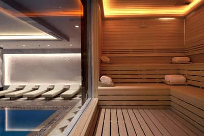 Lazzoni Hotel - a sauna with chairs and a swimming pool at Lazzoni Hotel in Istanbul