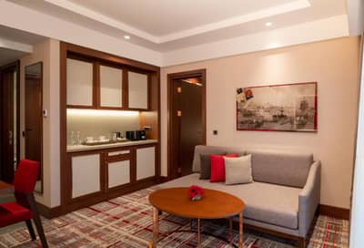 Mövenpick Hotel Istanbul Asia Airport - a living room with a couch and a table at Mövenpick Hotel Istanbul Asia Airport in Istanbul