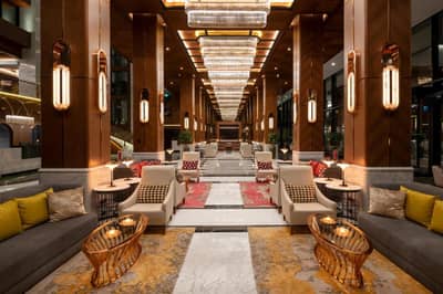 Mövenpick Hotel Istanbul Asia Airport - a lobby of a hotel with couches and tables at Mövenpick Hotel Istanbul Asia Airport in Istanbul