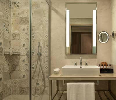 Mövenpick Hotel Istanbul Asia Airport - a bathroom with a sink and a shower at Mövenpick Hotel Istanbul Asia Airport in Istanbul