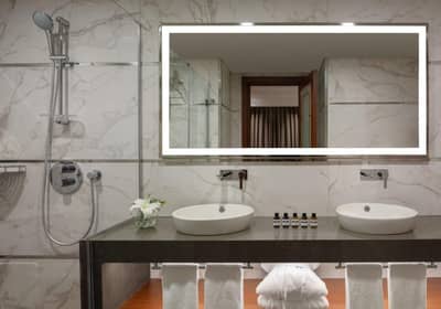 Mövenpick Hotel Istanbul Asia Airport - a bathroom with two sinks and a mirror at Mövenpick Hotel Istanbul Asia Airport in Istanbul
