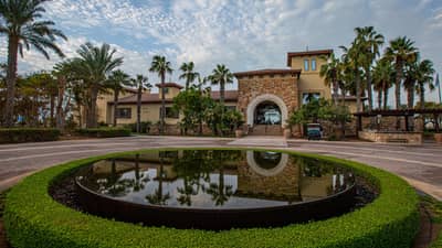 Saadiyat Beach Golf Club entrance with palm trees, Dubai venue.