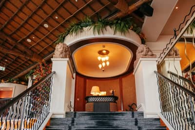 Elegant interior of Lion in the Sun Dubai with staircase and decor.