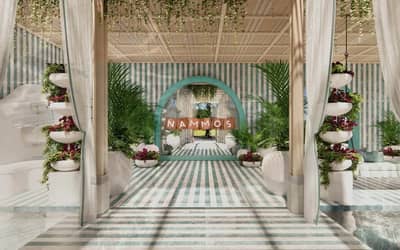 Elegant interior of Nammos Dubai with striped decor and plants.
