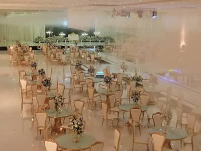 Elegant event setup with floral arrangements at Venice Wedding Hall Najran, Saudi Arabia.