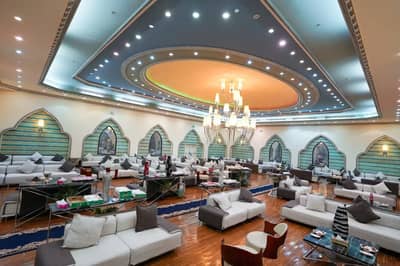 Elegant seating area with chandeliers at One Thousand and One Nights Wedding Hall Madinah.