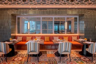 Elegant dining area at La Sirene Restaurant, Dubai with colorful decor.