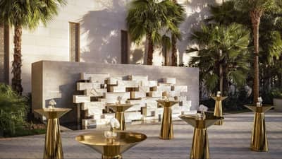 Elegant outdoor setup at Atlantis The Royal, Dubai with palm trees.