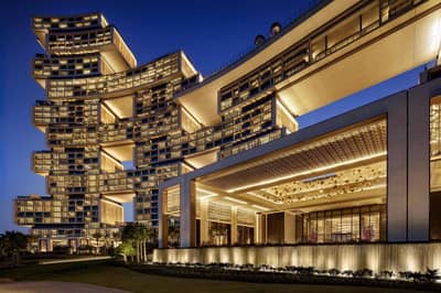 Illuminated Atlantis The Royal Dubai at night with modern architecture.