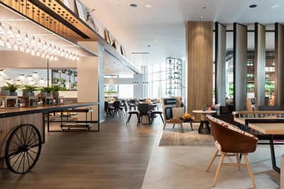 Modern interior of Zabeel House The Greens, Dubai, with seating areas.