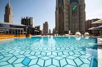 Rooftop pool at Zabeel House The Greens, Dubai, with city skyline.