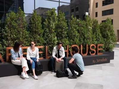 People sitting outside Zabeel House The Greens, Dubai.