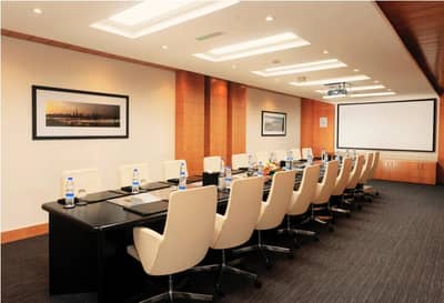 Dubai World Trade Centre meeting room with projector and framed artwork.
