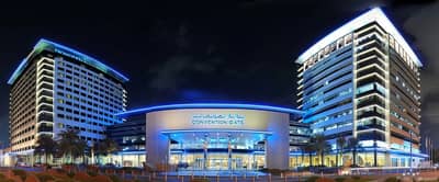 Dubai World Trade Centre illuminated at night, Dubai skyline backdrop.