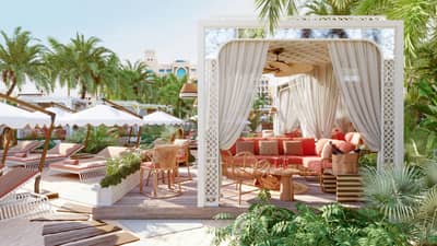 Maison de La Plage outdoor lounge with palm trees, Dubai.