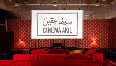 Cinema Akil interior with red seating, Dubai.