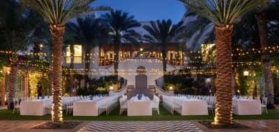 Elegant outdoor dining setup at Dubai Creek Golf & Yacht Club.