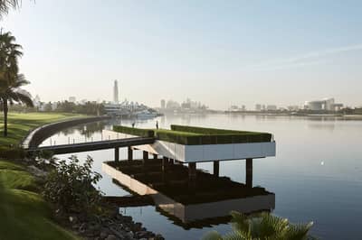Dubai Creek Golf & Yacht Club overlooking serene water and cityscape.