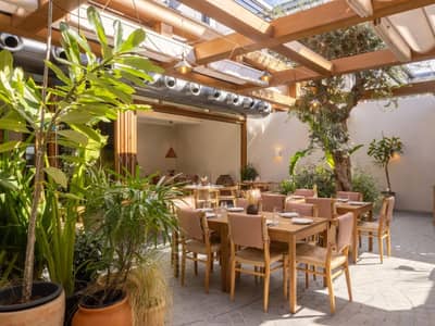 Outdoor dining area at Mythos Urban Greek Eatery, Dubai.