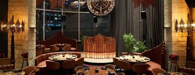 Cozy dining setup with circular tables at Amelia, Dubai.