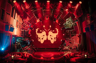 Babylon Difc Dubai stage with dramatic red lighting and decor.