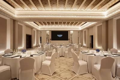 Elegant banquet hall at Madinat Jumeirah, Dubai, with round tables.