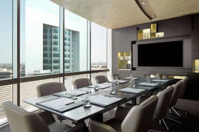 Modern conference room at Jumeirah Emirates Towers, Dubai with city view.