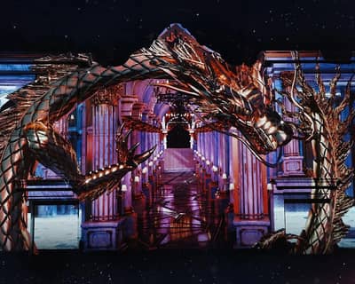 DREAM Dubai venue with ornate dragon and grand staircase.