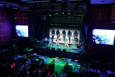 Boracay Night Club stage with performers and colorful lights in Dubai.
