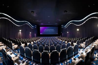 Spacious theater at Reel Cinemas, Dubai Marina Mall, with empty seats.
