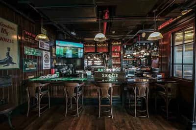 Cozy interior of McCafferty's Pub Jumeirah Village, Dubai with wooden decor.
