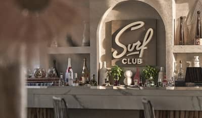 Surf Club Dubai bar with bottles and decorative elements.