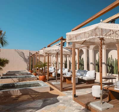 Luxurious cabanas at Be Beach DXB, Dubai, with poolside view.