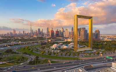 Zabeel Park with Dubai skyline and iconic frame structure.