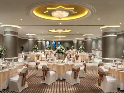 Elegant round table setup at Kempinski Hotel Ajman ballroom.