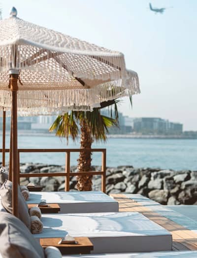 Beachside lounge area at Be Beach DXB, Dubai with ocean view.
