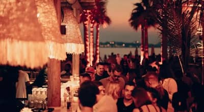 Crowded evening at Surf Club Dubai with beachside ambiance.