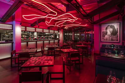 Hawkerboi restaurant interior with red lighting, Dubai.