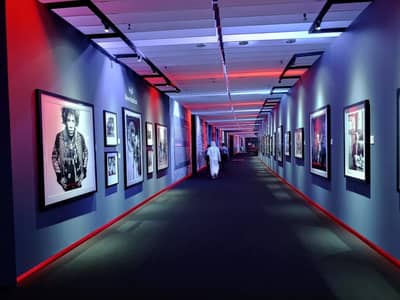 Expo Centre Sharjah corridor with framed photos and colorful lighting.