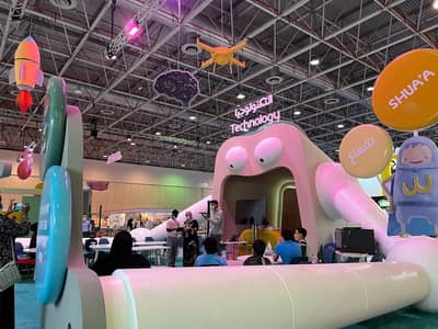 Expo Centre Sharjah technology exhibit with colorful decorations and visitors.