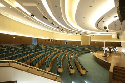 Hct Dubai Al-Nahda Campus Auditorium with curved seating and stage.