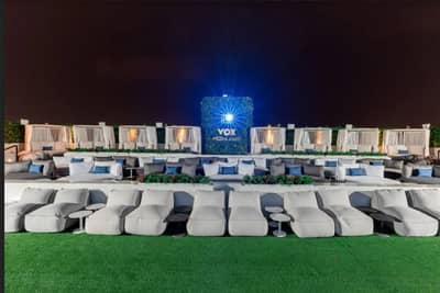 Outdoor seating at VOX Moonlight, Dubai, under night sky.