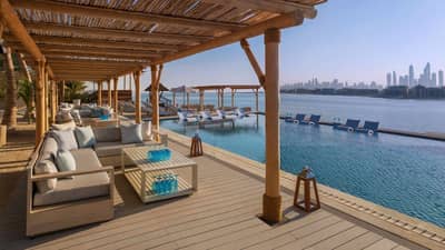 Kyma Beach Dubai lounge area overlooking the sea and city skyline.