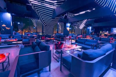 The Penthouse Dubai lounge with modern seating and neon lighting.