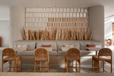 Mythos Urban Greek Eatery interior with woven chairs, Dubai.