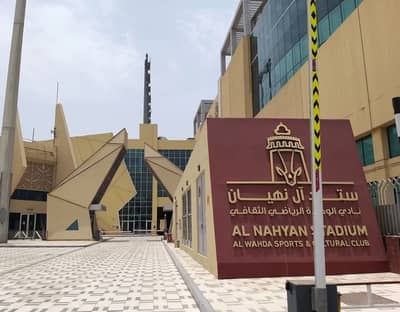 Entrance of Al Nahyan Stadium, Abu Dhabi, with modern architecture.